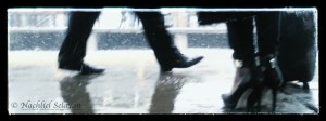 New Brunswick train station, New Jersey - commuters' legs crossing wet pavement