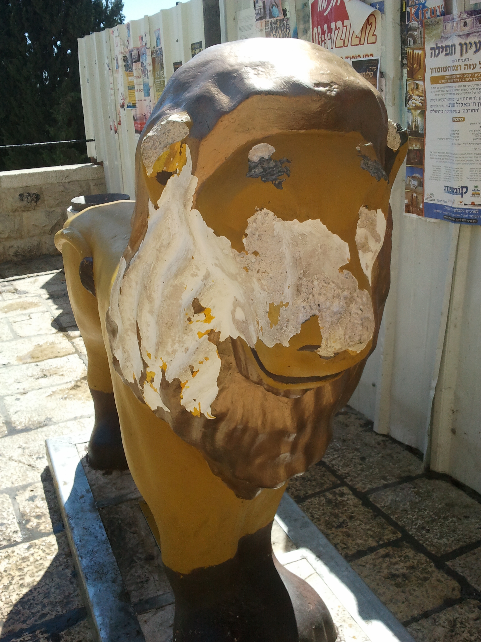 One of the Jerusalem lion sculptures with its paint stripped and peeling away