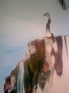 Detail of the mural: the ibex standing on the cliff edge above the falls