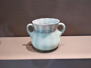 Pale blue two-handled glass sugar bowl on a display plinth